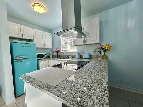 Kitchen with a cooktop and range hood