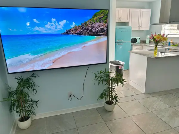 Living room TV with the kitchen behind
