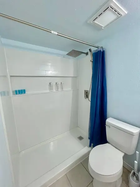 Shower with a glass shelf and curtain