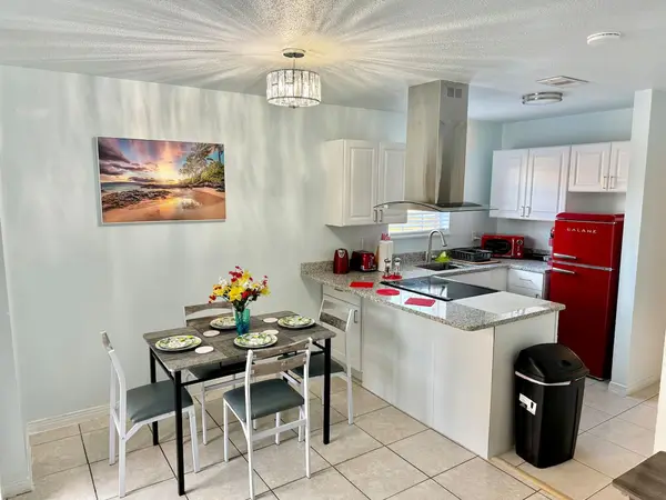 Open kitchen and dining area with a retro red fridge