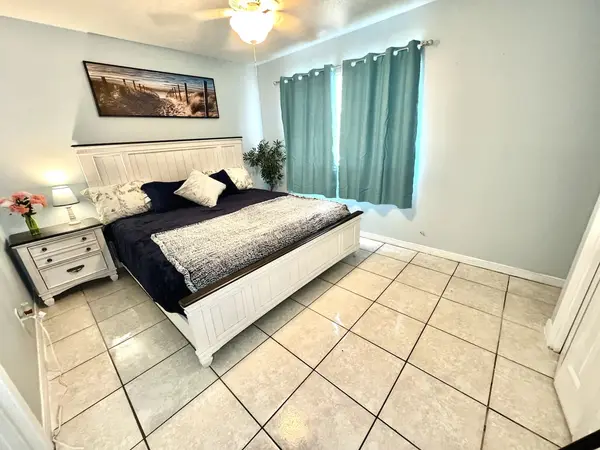 Bedroom with a double bed and teal curtains