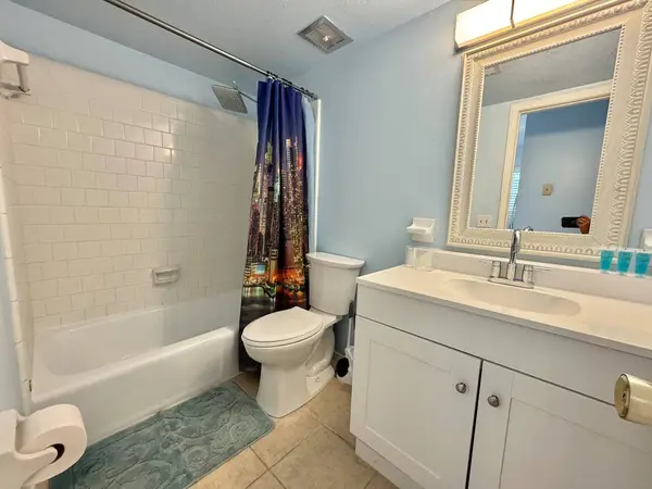 Bathroom with a shower over the bath