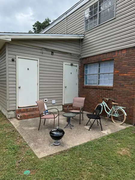Covered porch with seating and a bicycle