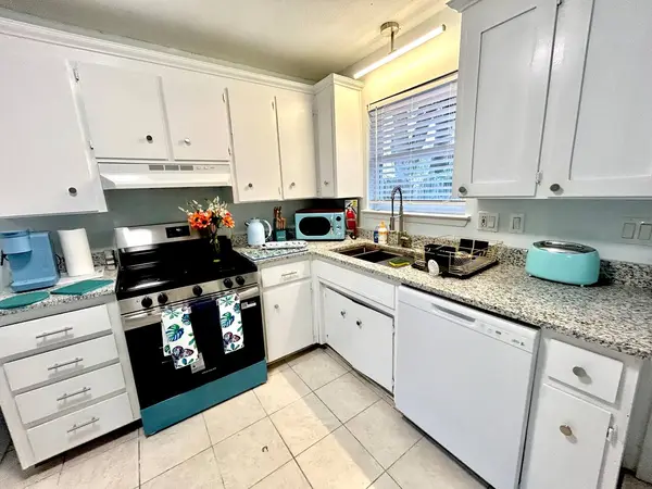 Kitchen with a stove, dishwasher and window